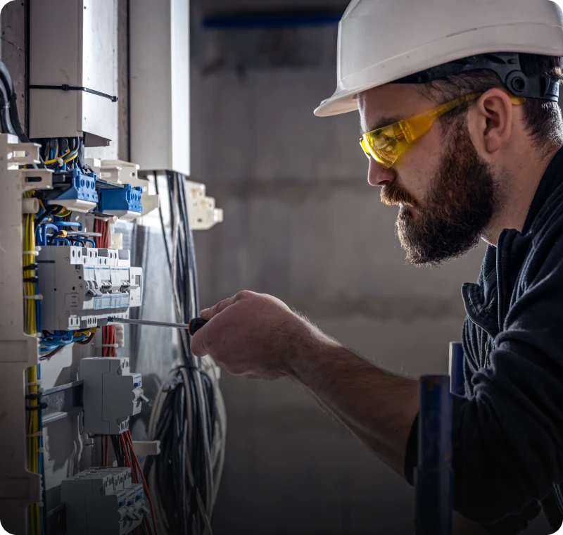 Technician using screwdriver on wiring system