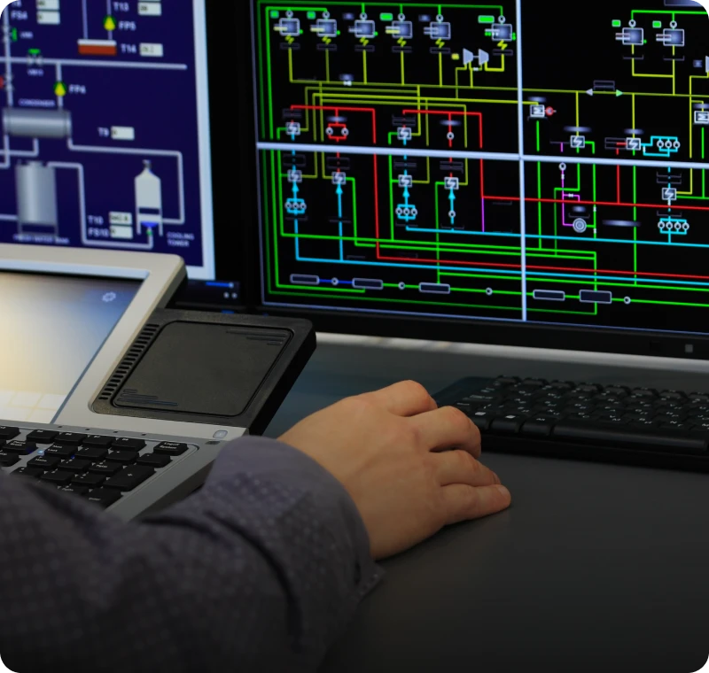 Person analyzing industrial process on monitors